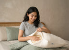 Morning Owl Shredded Natural Latex Pillow – Woman Adjusting Shredded Latex Filling Inside Pillow on Bed – Customizable Firmness Natural Pillow India